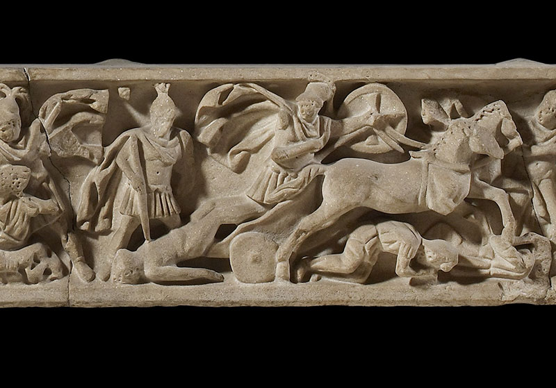 Detail from a Roman sarcophagus lid depicting Achilles dragging Hector’s body behind his chariot c. AD175-200; Photograph © Ashmolean Museum, University of Oxford
